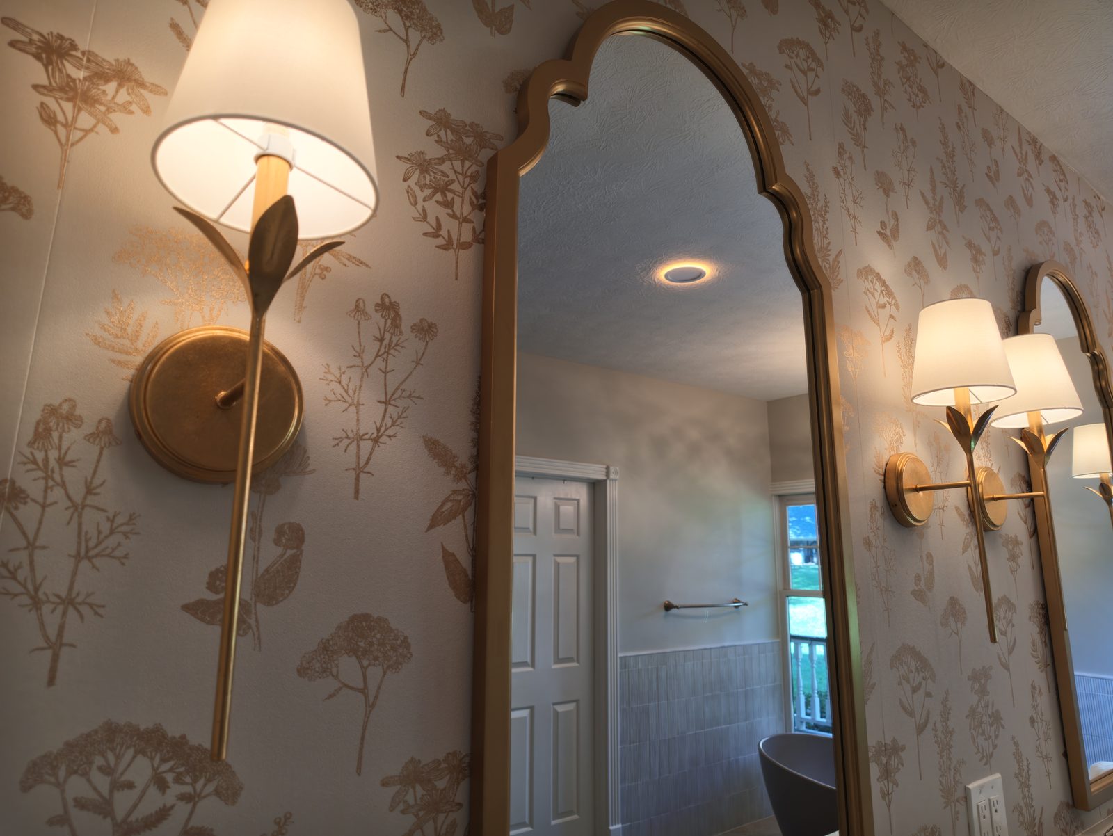 Gold ogee arch mirror with sconces and botanical toile wallpaper Noblesville Indiana