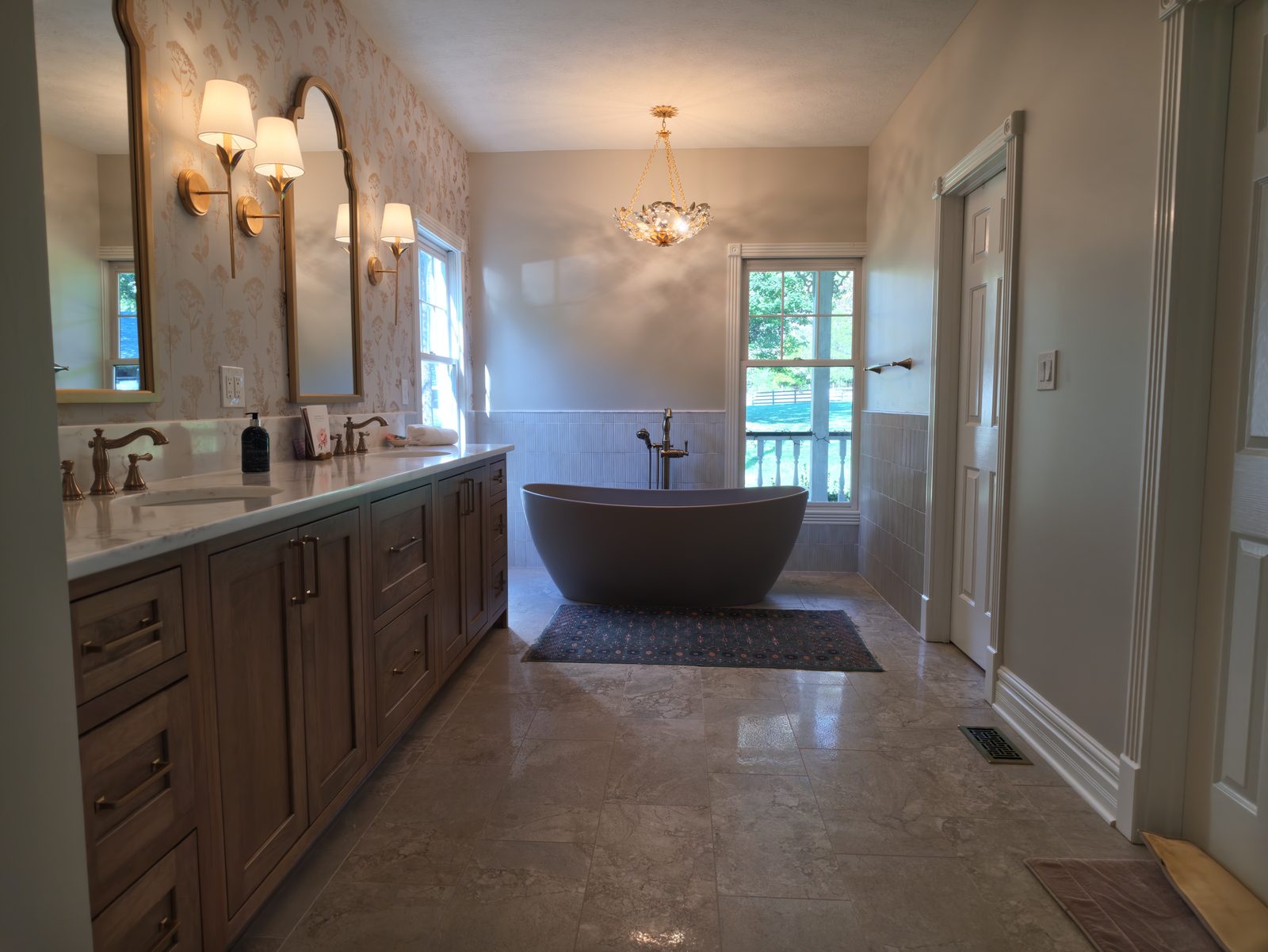 Primary bath with stone top double vanity and freestanding tub Noblesville IN
