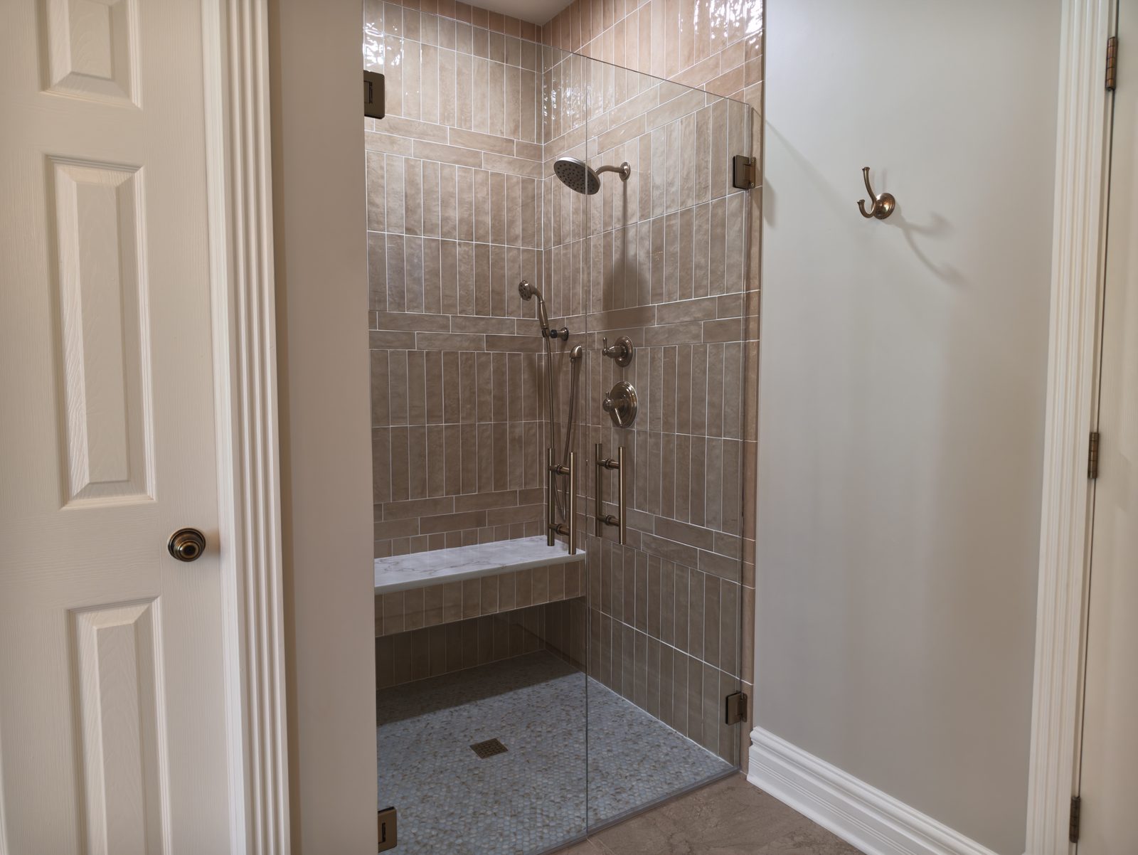 Curbless walk-in shower with frameless glass and tiled bench Noblesville Indiana
