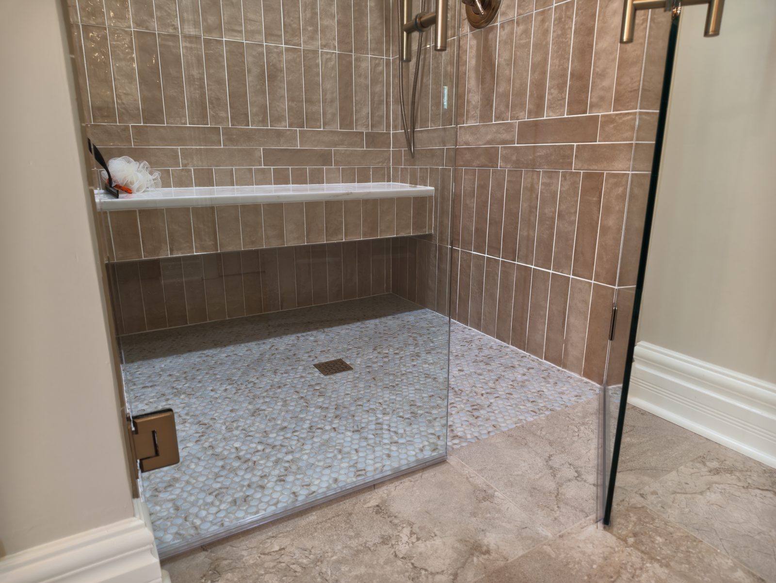 Curbless shower entry where the mosaic pan meets the bathroom floor Noblesville Indiana