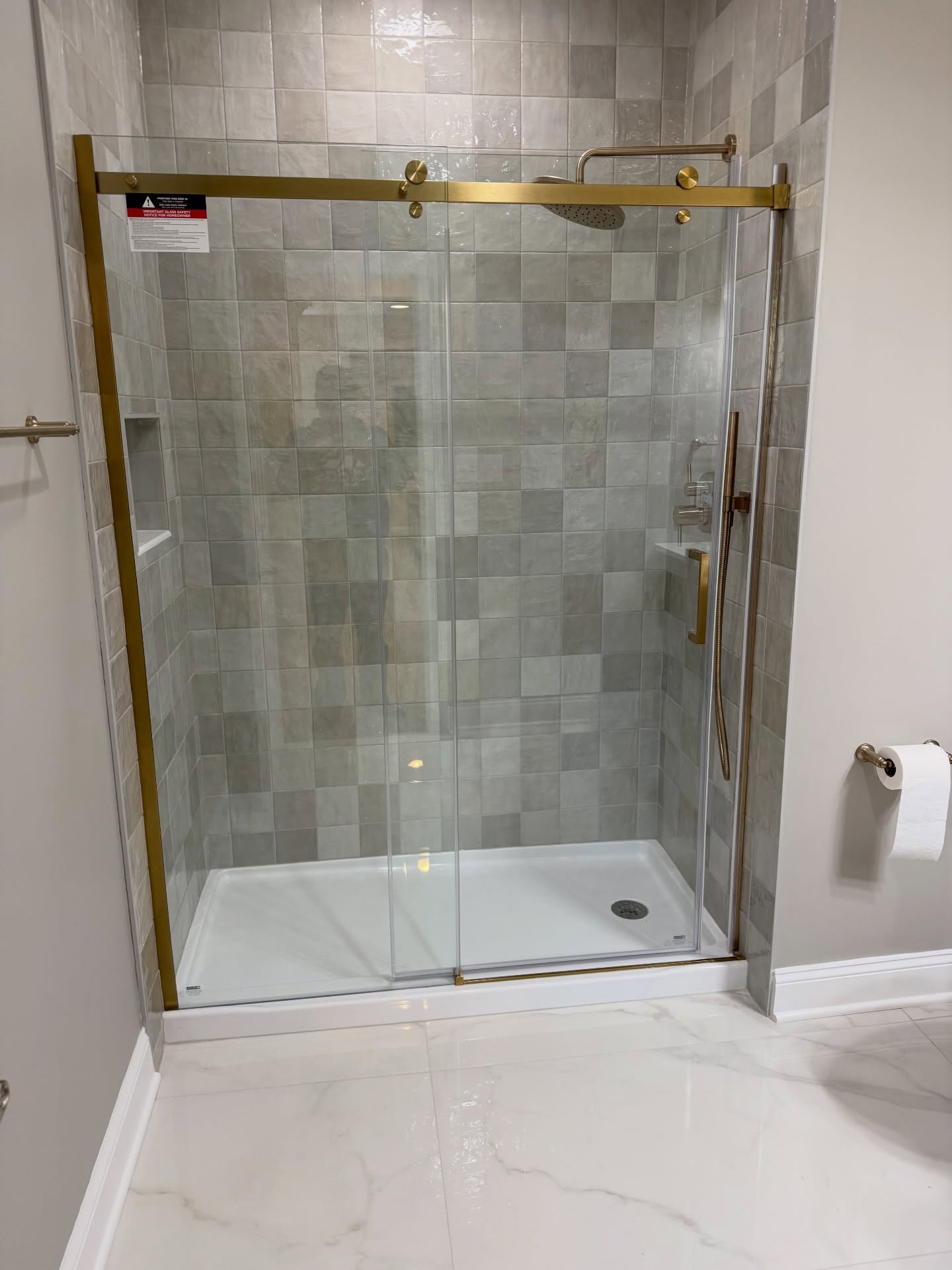 Glass shower brushed gold accents basement bath Carmel Indiana