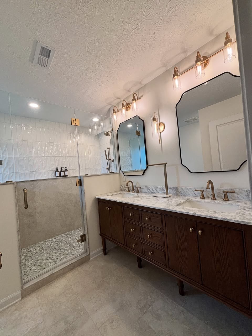 Full gut bathroom remodel with walk-in shower and dark stained double vanity Fishers Indiana