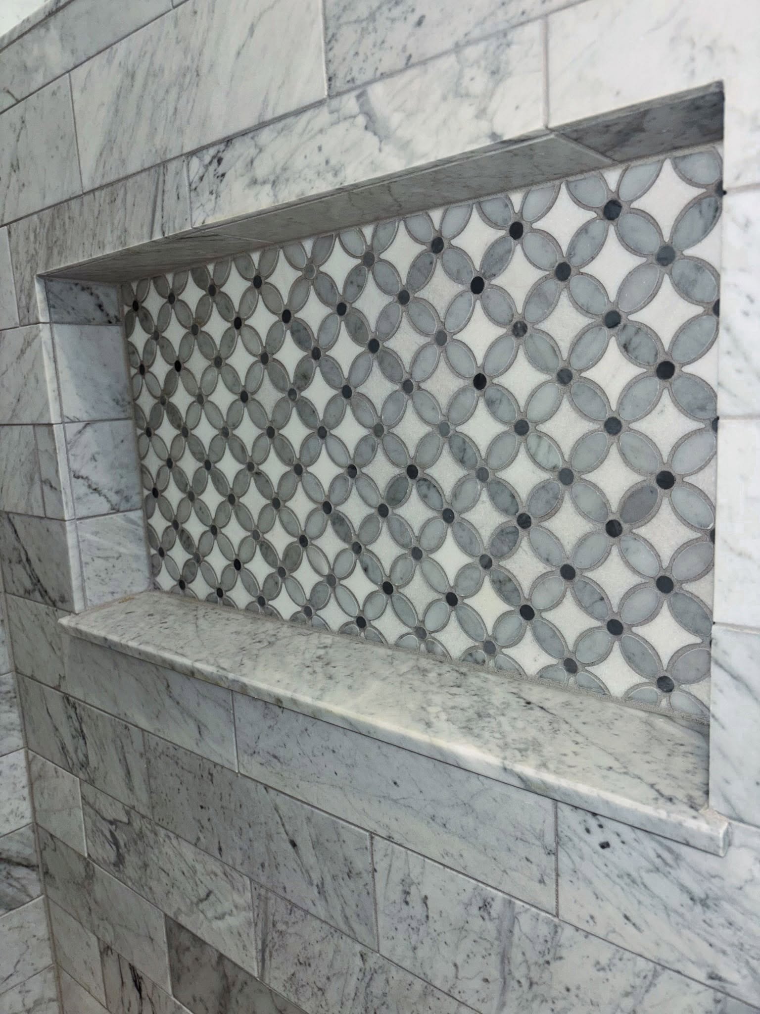 Mosaic flower pattern accent niche marble bathroom Fishers IN