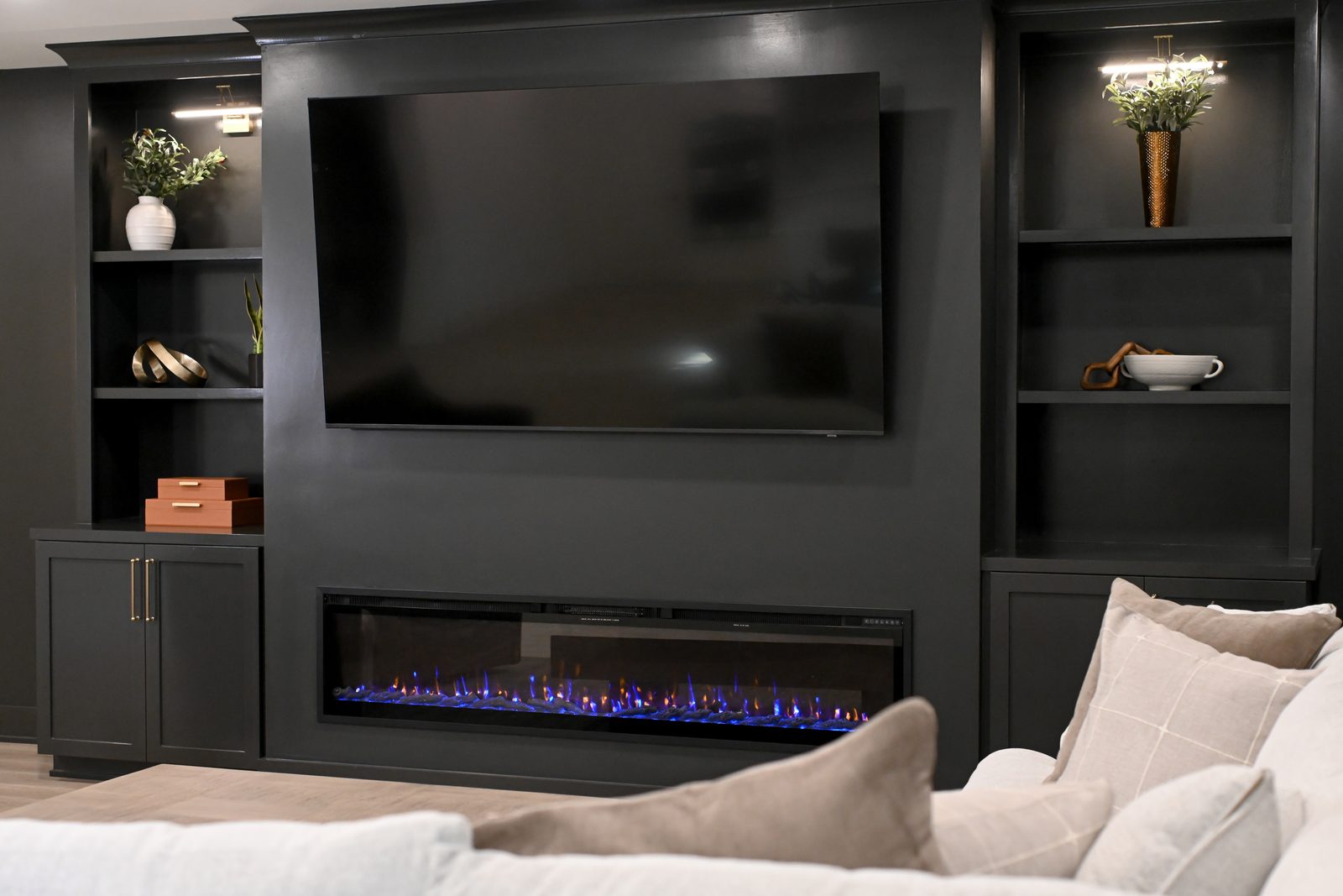 Basement fireplace wall with lit display shelving Westfield Indiana