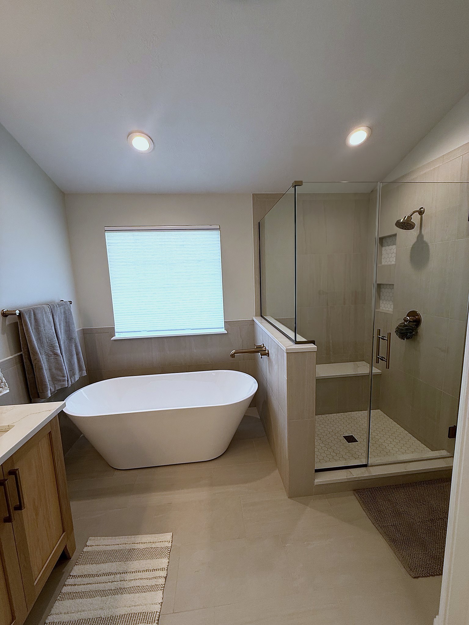 Primary bathroom with freestanding soaking tub and frameless glass shower Fishers Indiana