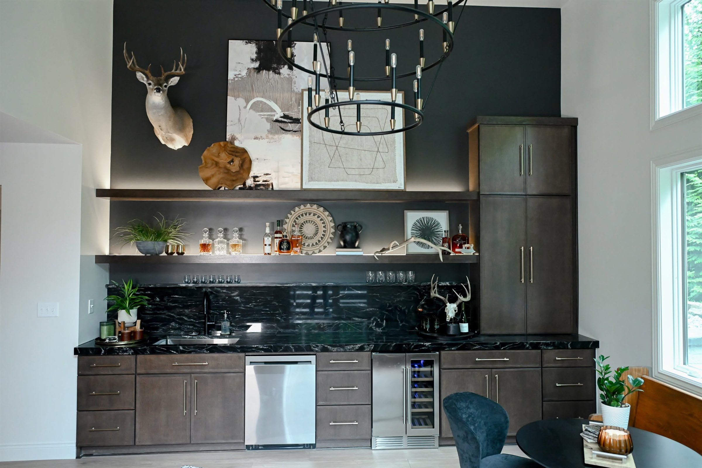 Basement wet bar with black stone countertop and full height slab backsplash Zionsville IN