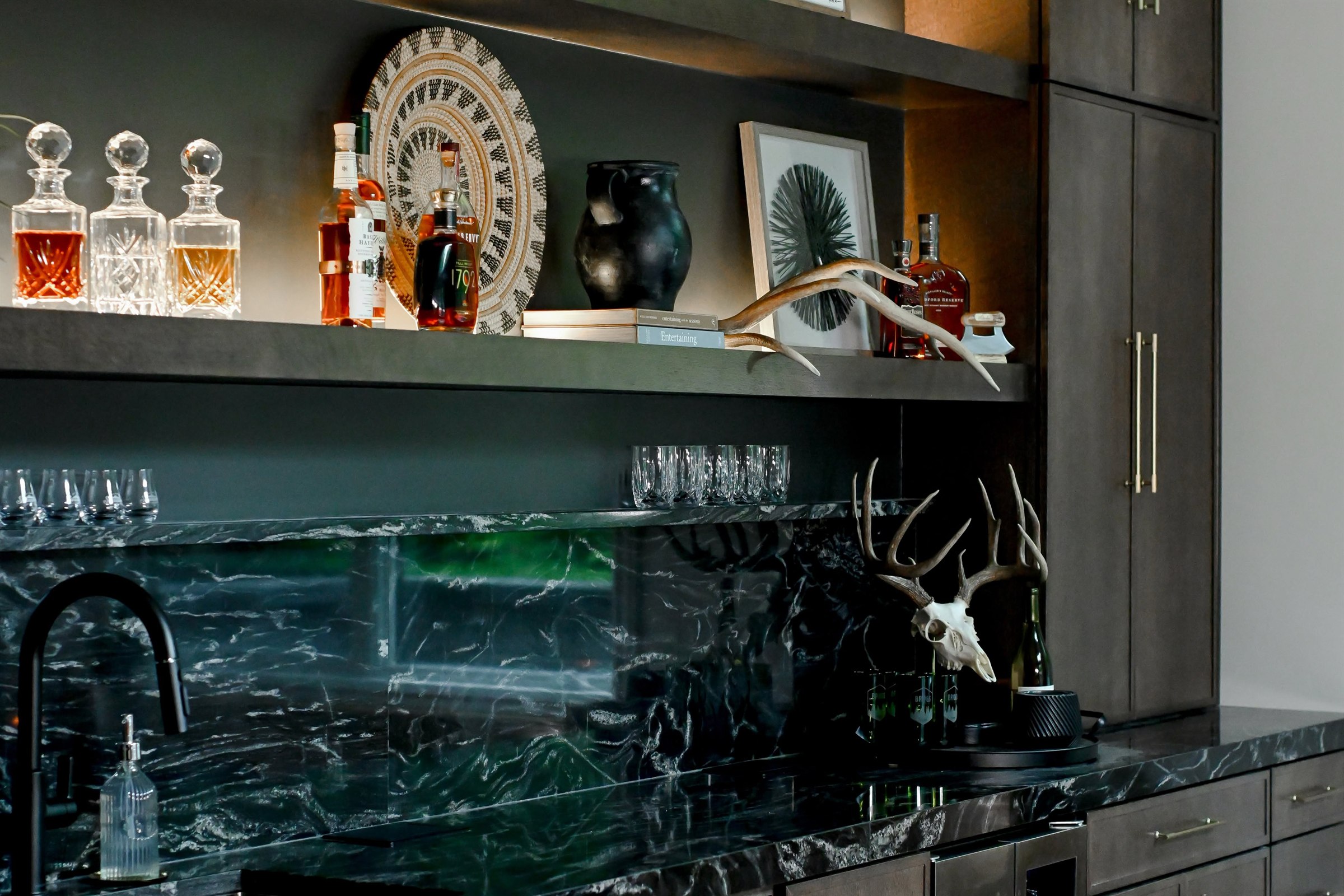 Full height polished black stone backsplash with floating LED shelves basement bar Zionsville IN