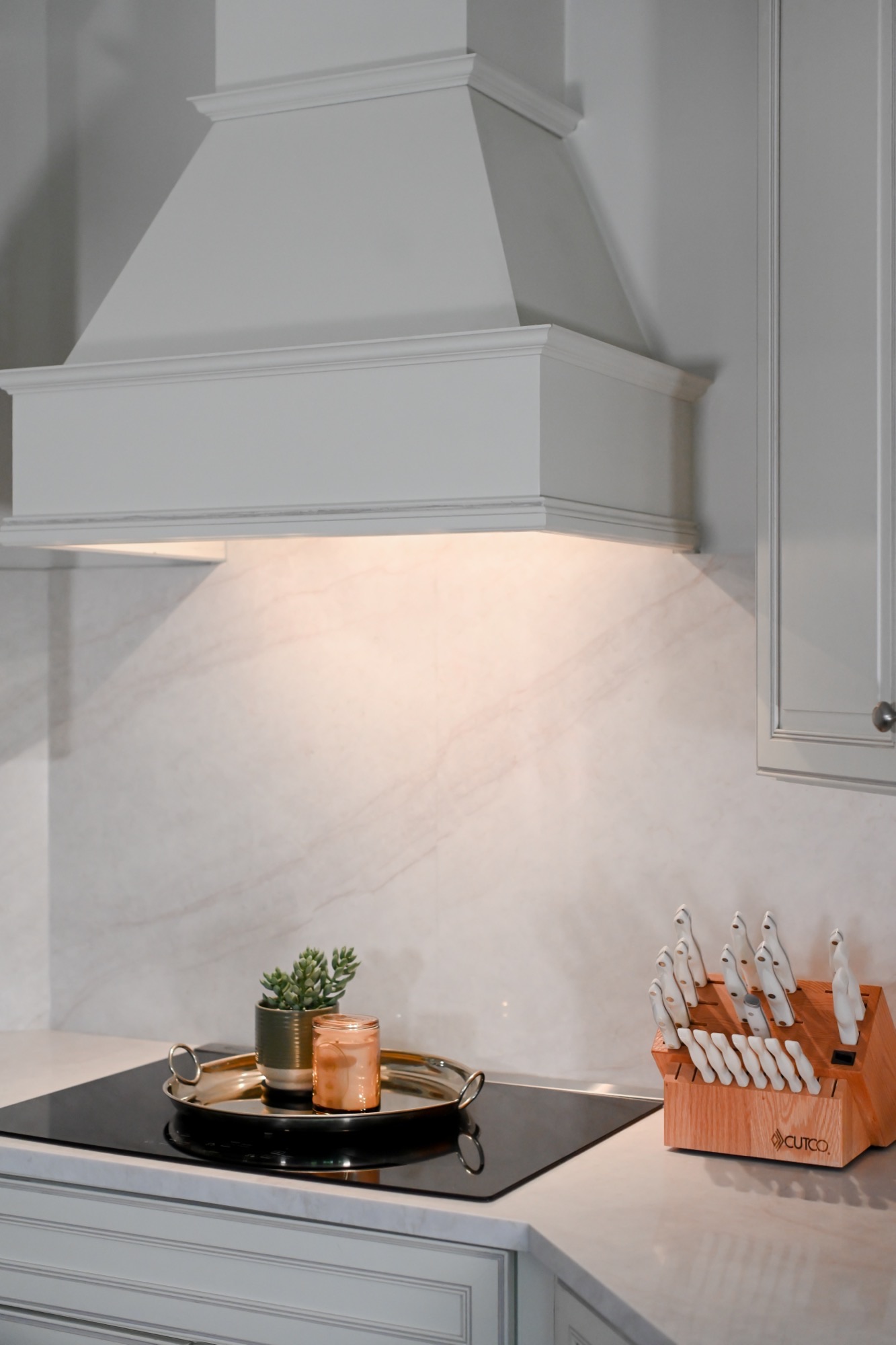 Custom painted range hood over full height marble slab backsplash Zionsville Indiana kitchen