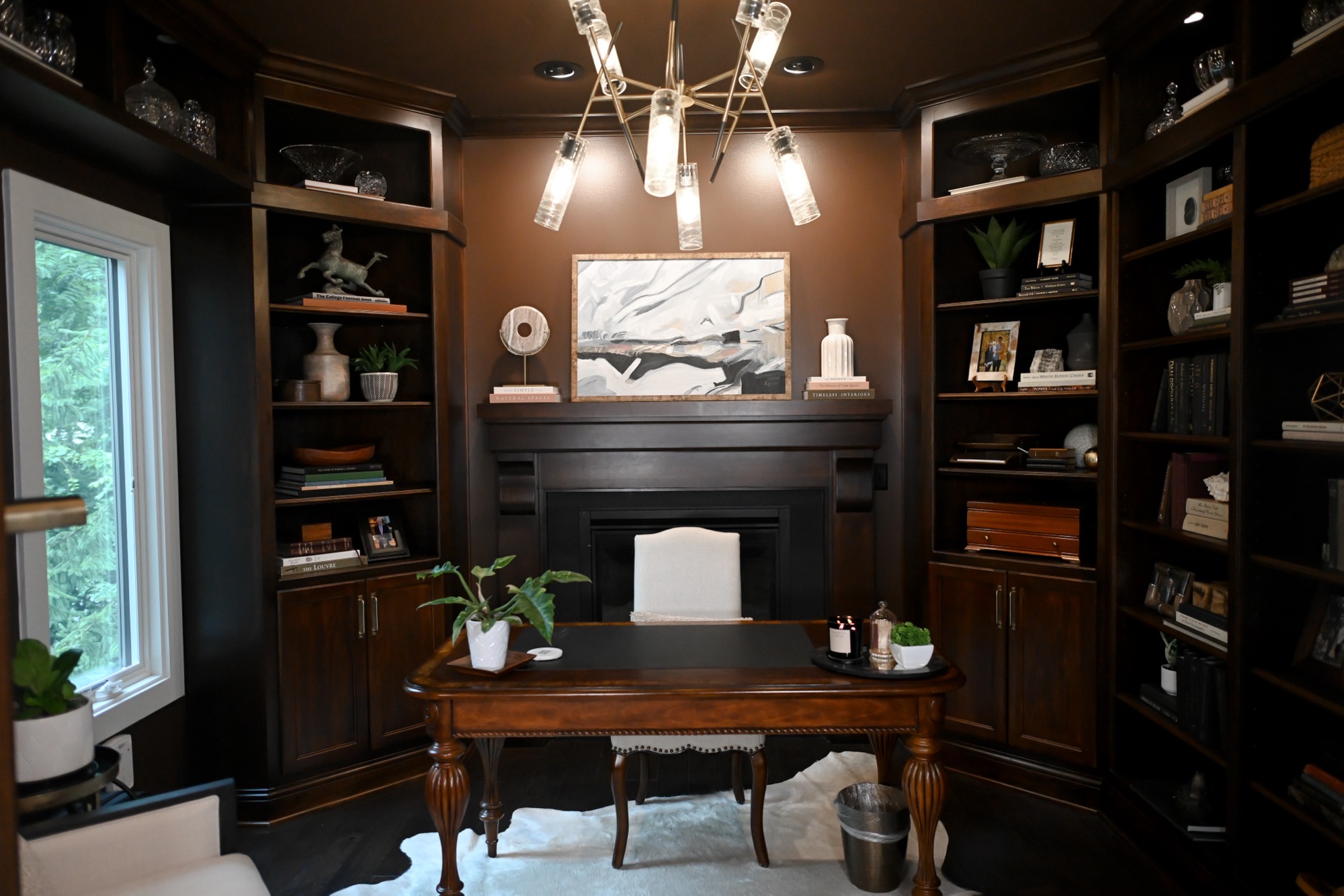 Chocolate brown study with floor to ceiling built-ins and fireplace Zionsville Indiana